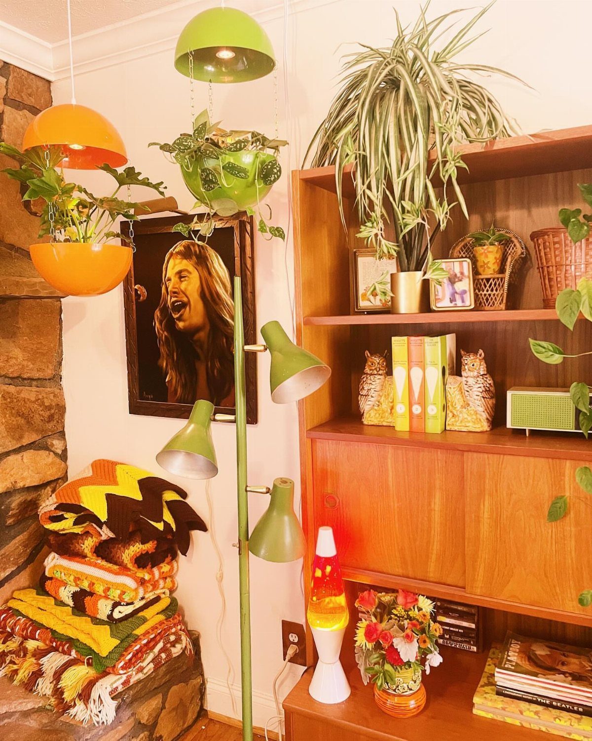 Orange and green hanging planters with indoor plants in a 70s retro room.