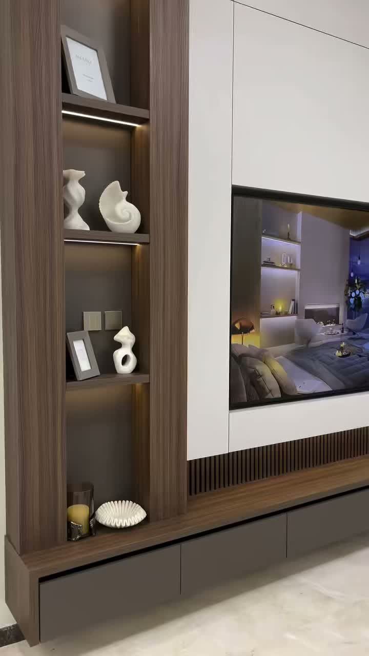 Recessed TV cutout in a white wall panel with brown wooden shelving units.