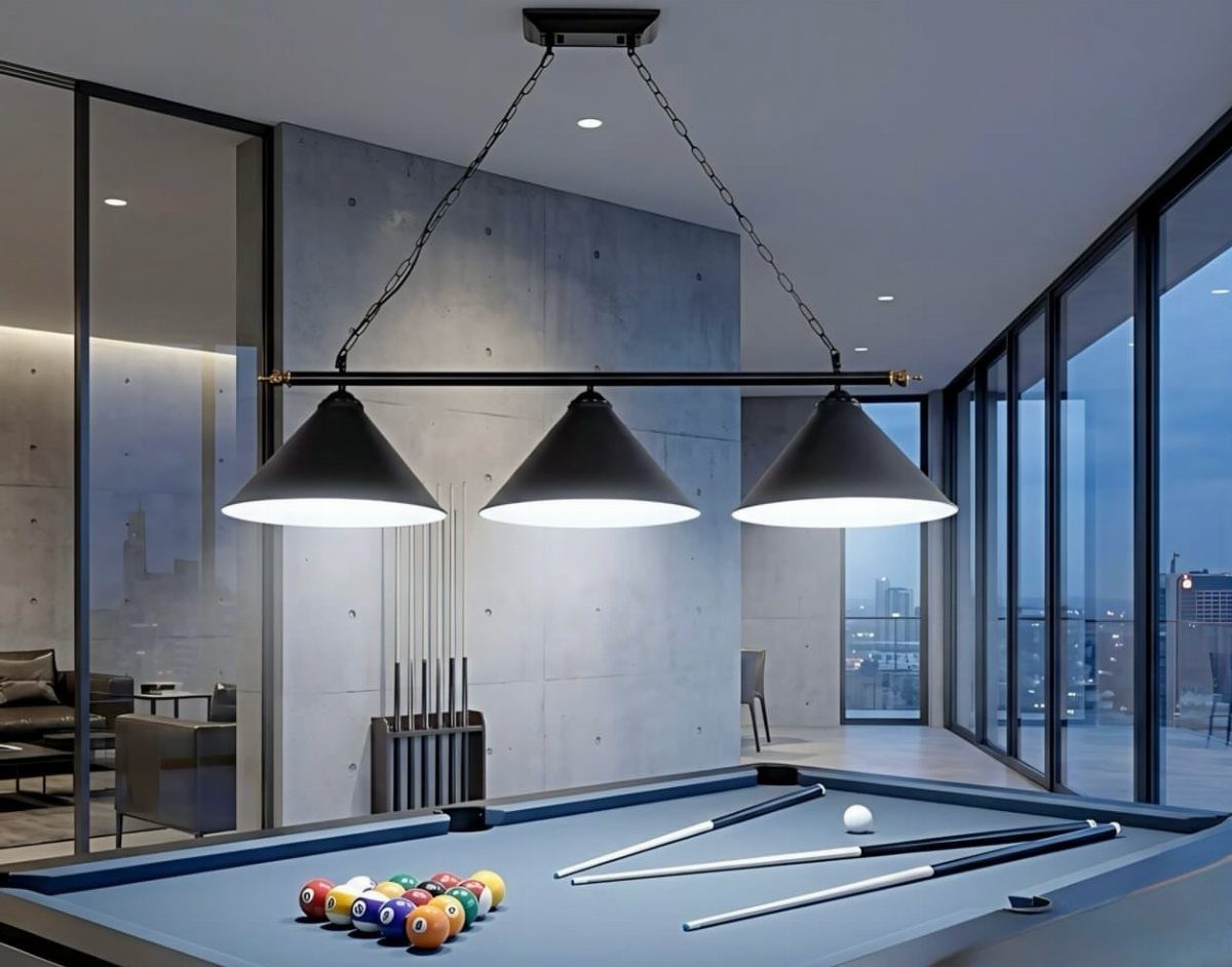 Blue pool table with black pendant lamps in a modern concrete room