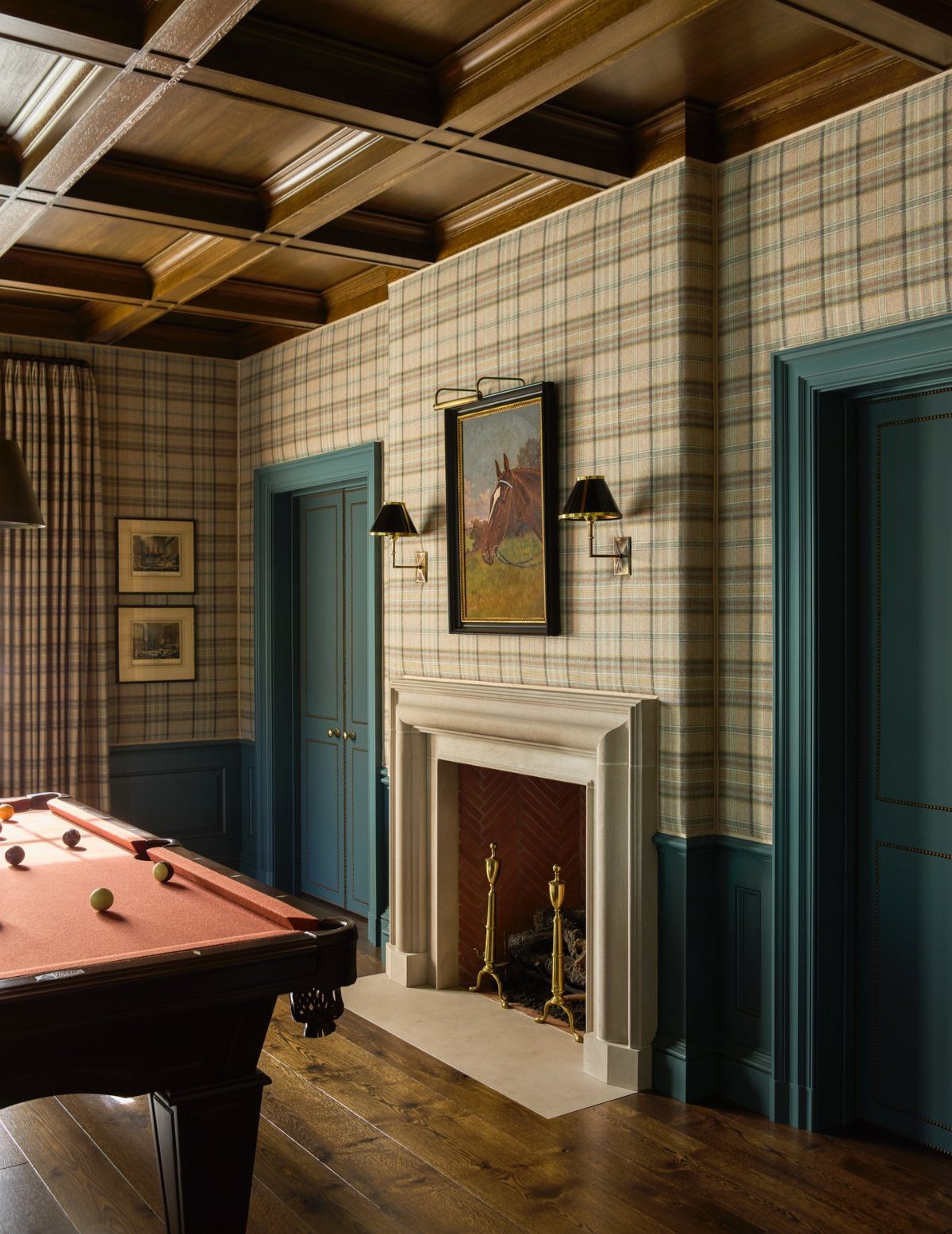 Dark hardwood floors in a billiard room with a red pool table and fireplace.