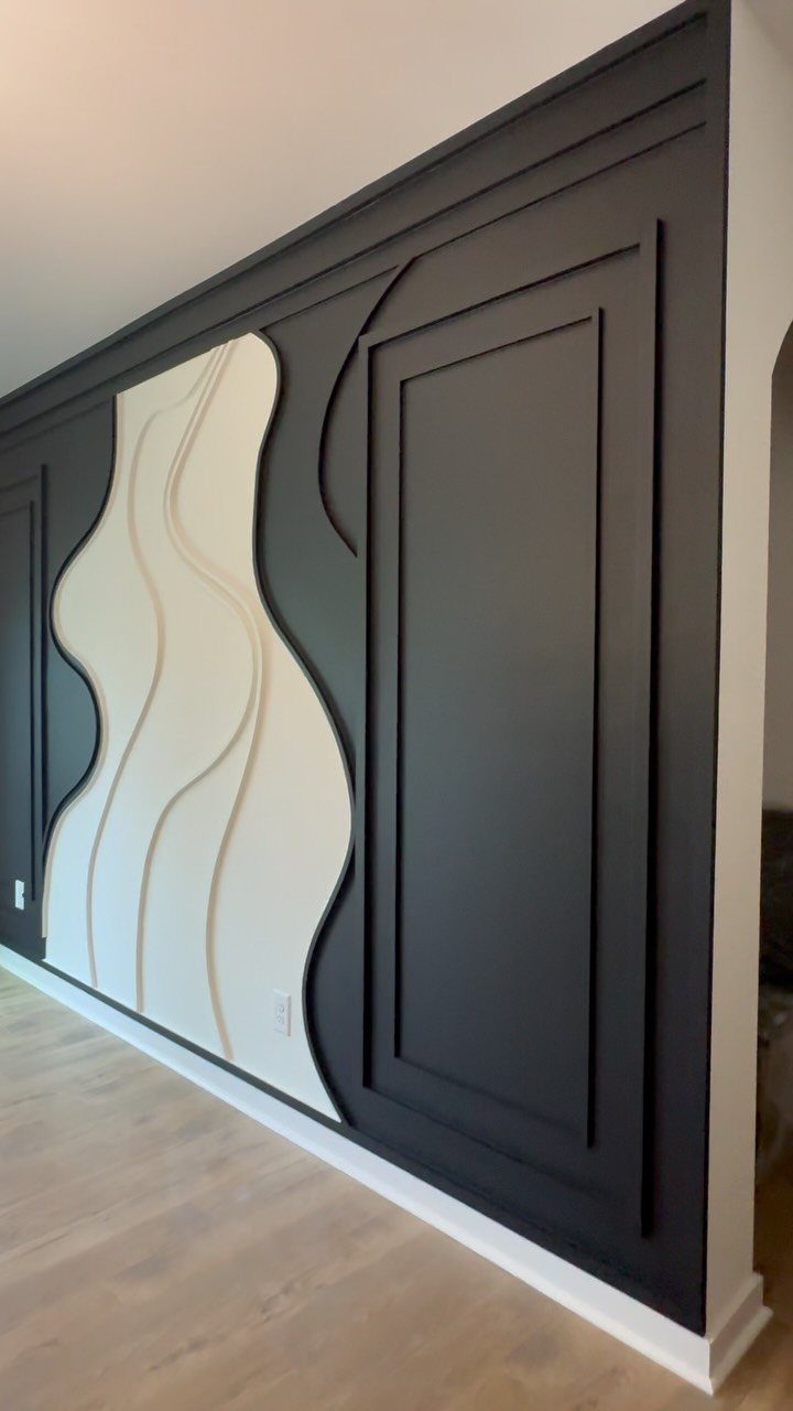 Black and white decorative wall molding with a wavy central white panel.