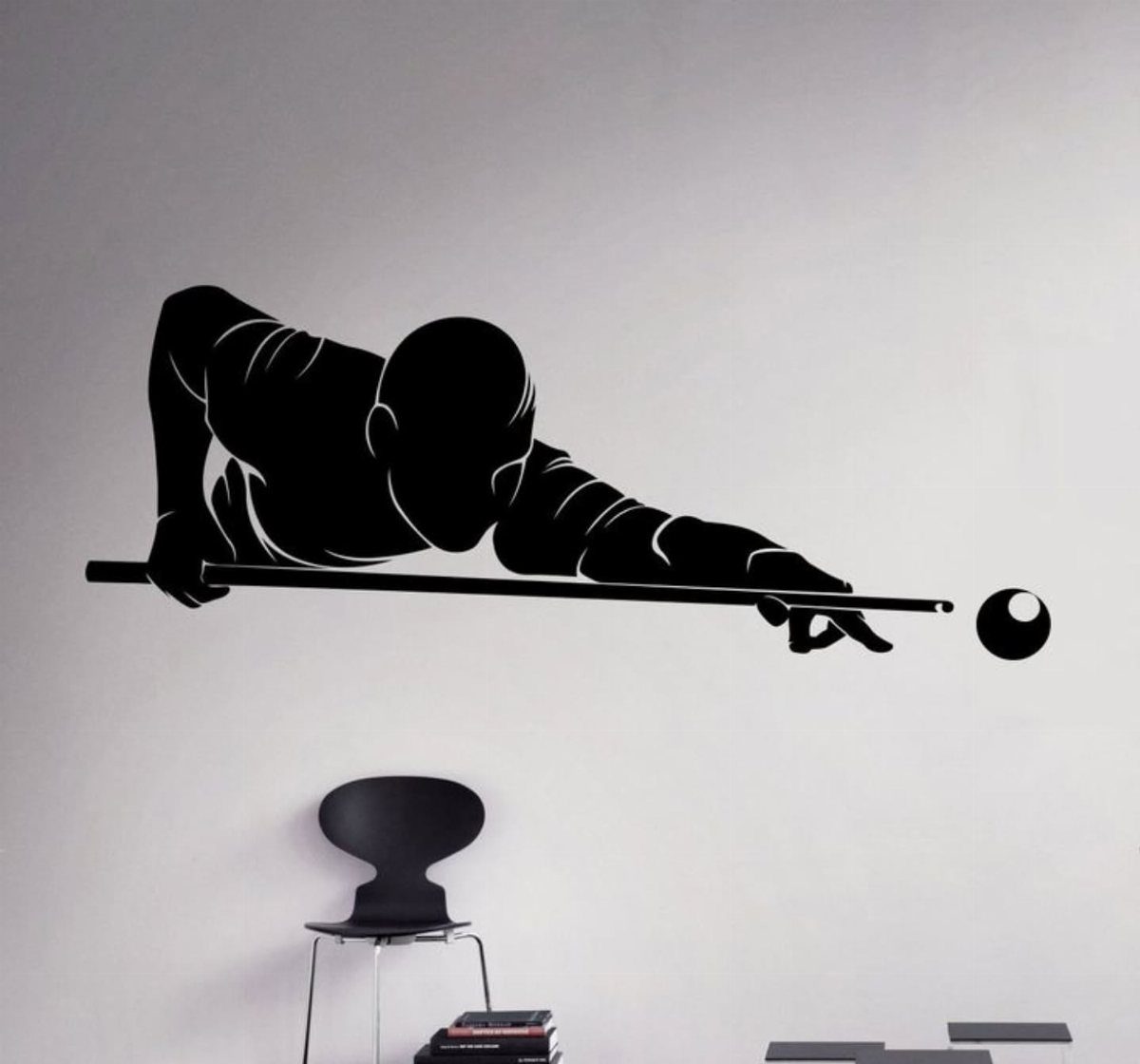 Black silhouette wall decal of a billiard player on a light grey wall