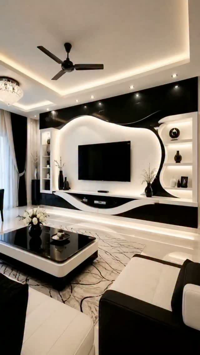 Modern living room with black and white furniture and a curved TV wall unit.