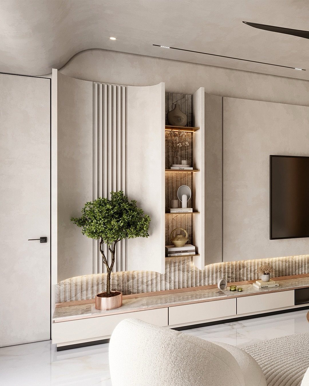Modern beige built-in entertainment center with curved walls, open shelving, and wall-mounted TV.