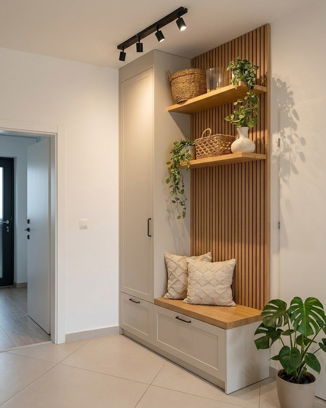 White built-in entryway unit with a wooden bench, drawers, and floating shelves.