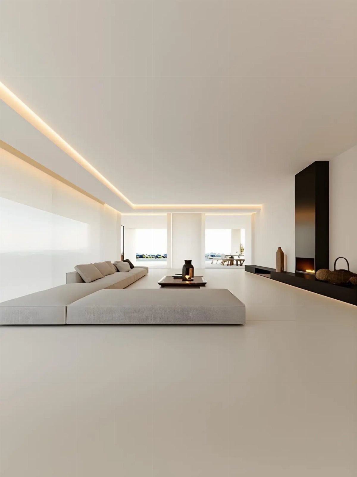 Minimalist luxury living room with white surfaces, grey sofa, and recessed ceiling lighting.