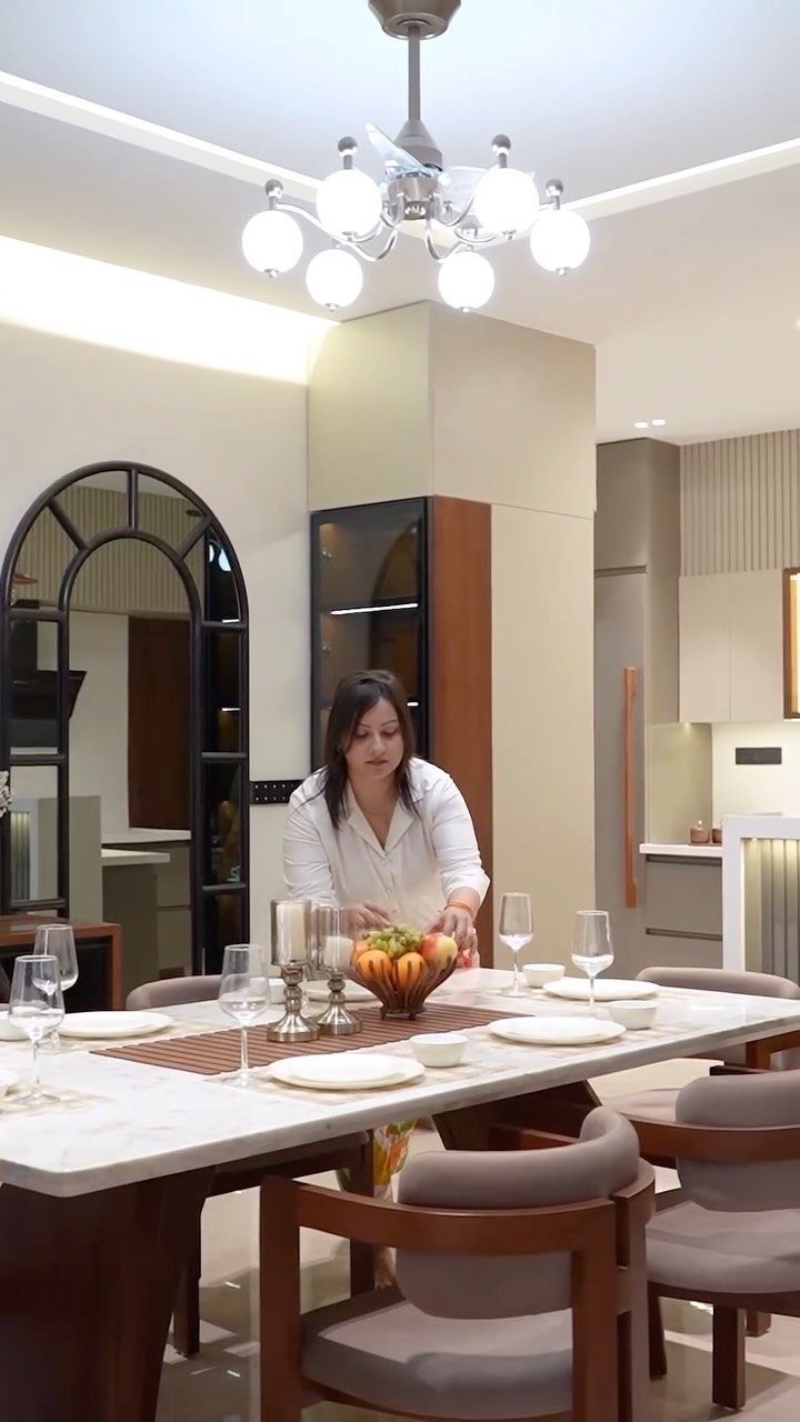 Woman standing by a marble dining table in a luxury contemporary dining room