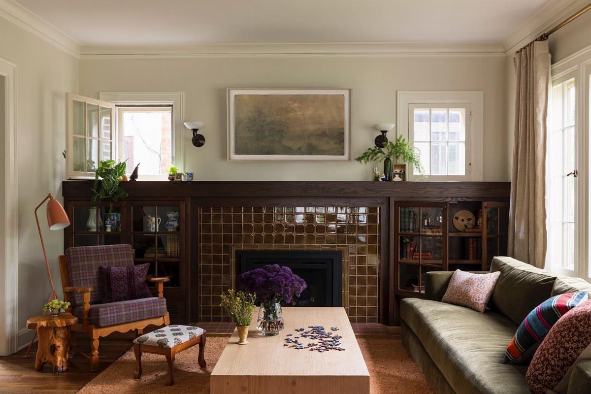 Dark wood built-in bookshelves flanking a tiled fireplace in a craftsman living room