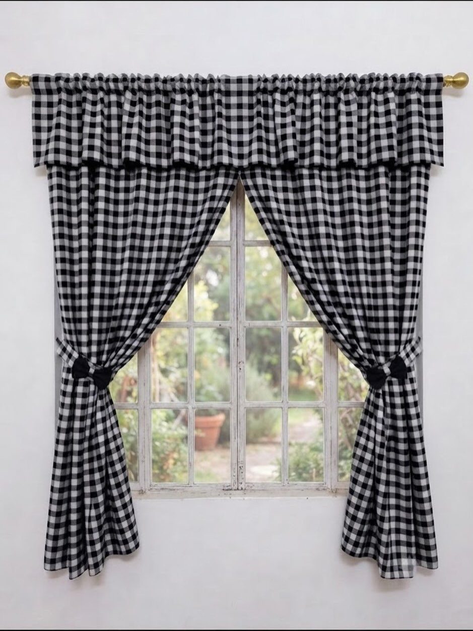 Black and white gingham curtains with a matching valance on a gold rod.