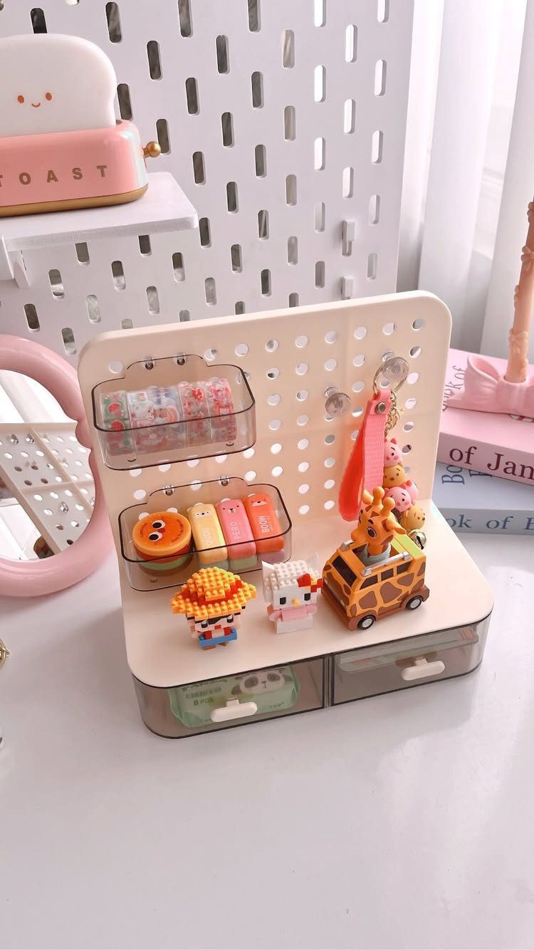 Cream desk organizer with colorful stationery and cute figurines on a white surface