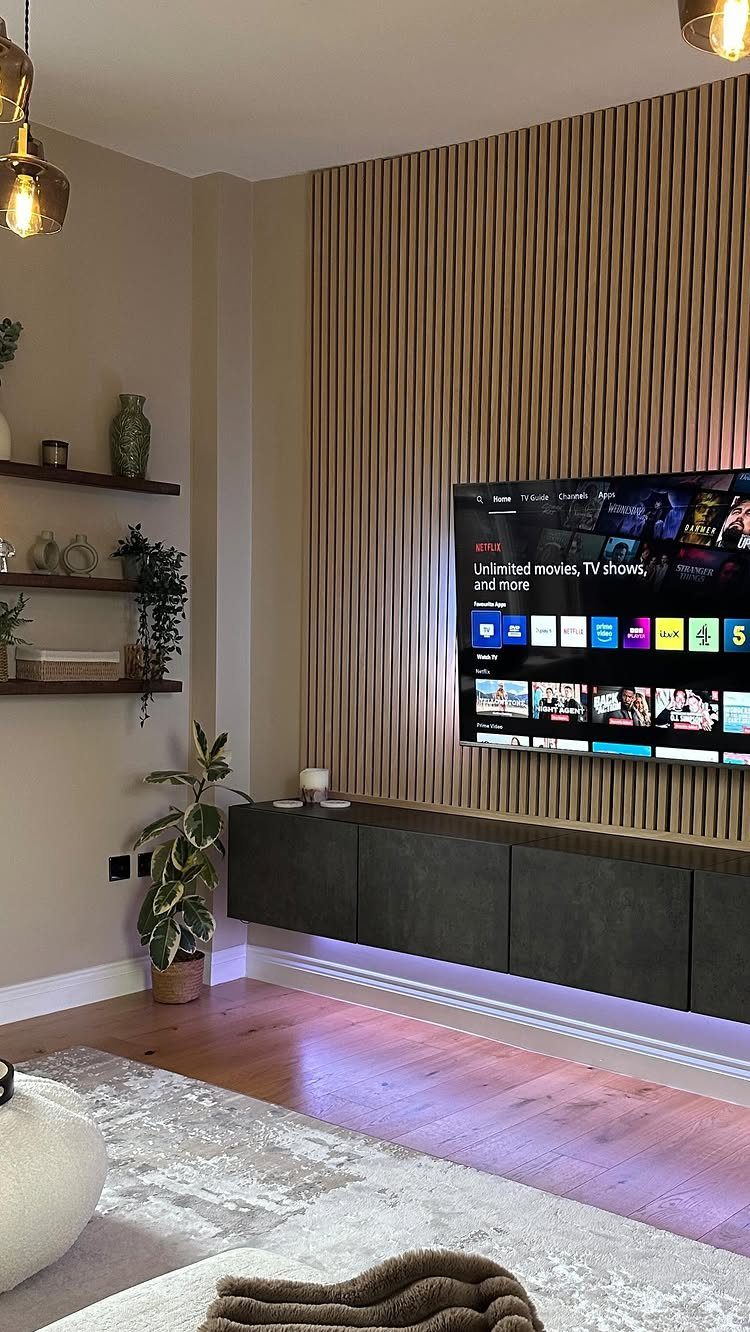 Floating shelves and a slatted wood wall in a modern living room setup.
