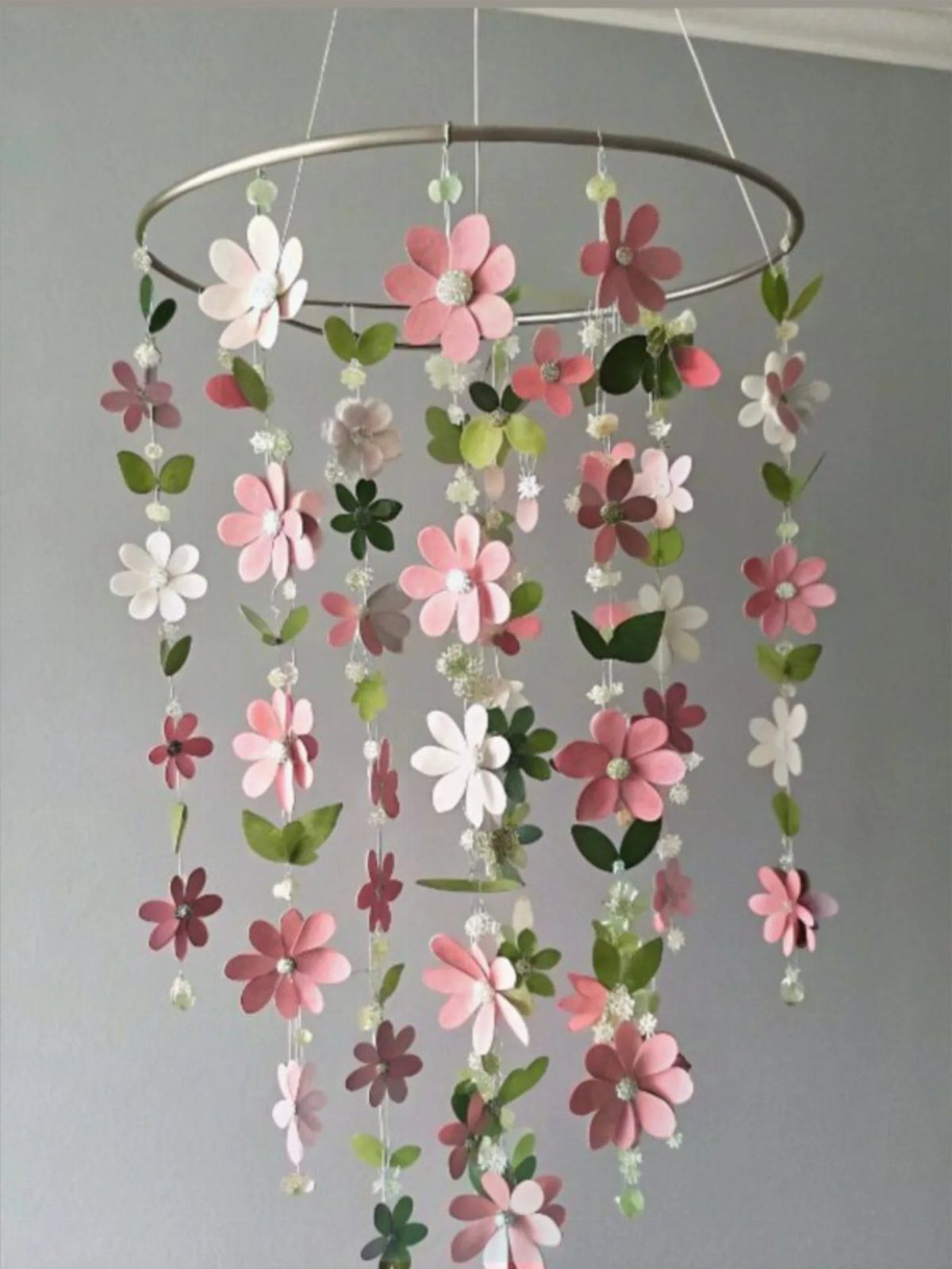 Paper flower wall hanging with pink and white blossoms on a metal hoop