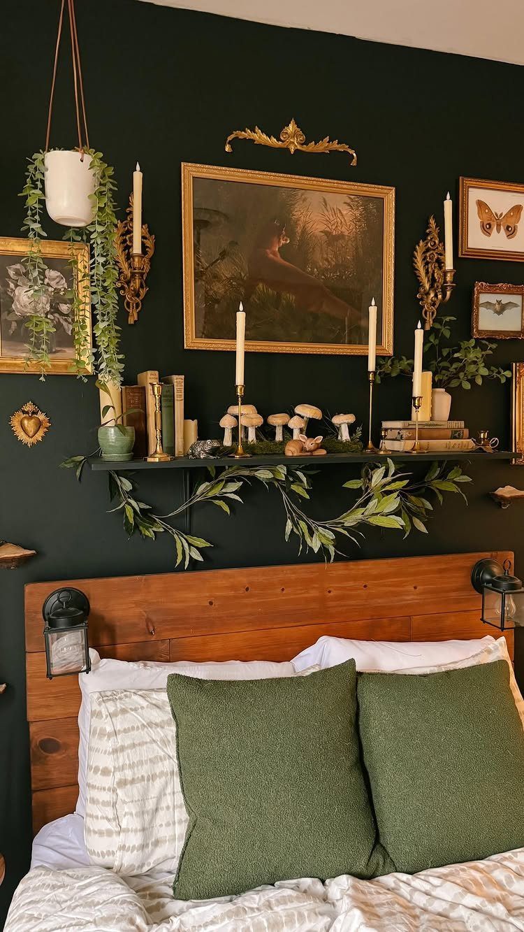 Gallery wall with framed art and candles above a wooden bed headboard.