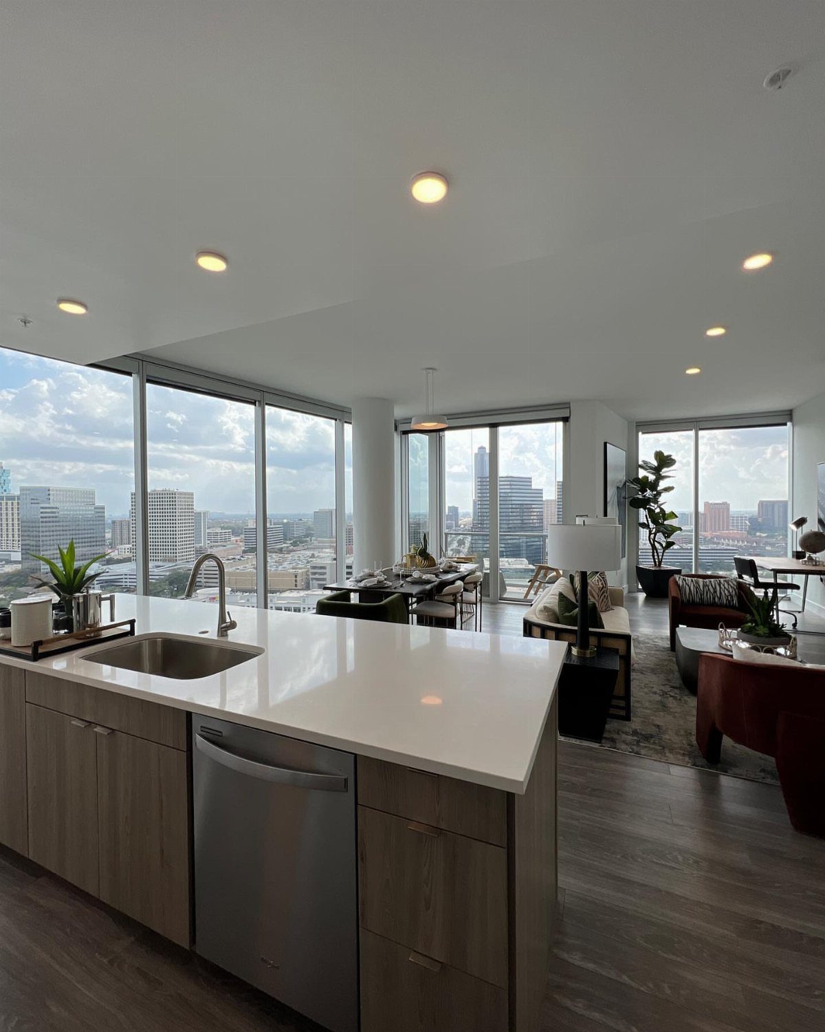 Modern apartment interior with floor-to-ceiling windows flooding the room with bright natural light.
