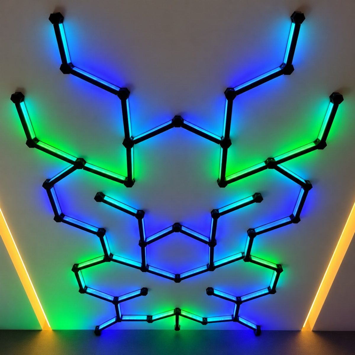 Modular LED light panels in blue and green forming a geometric ceiling pattern