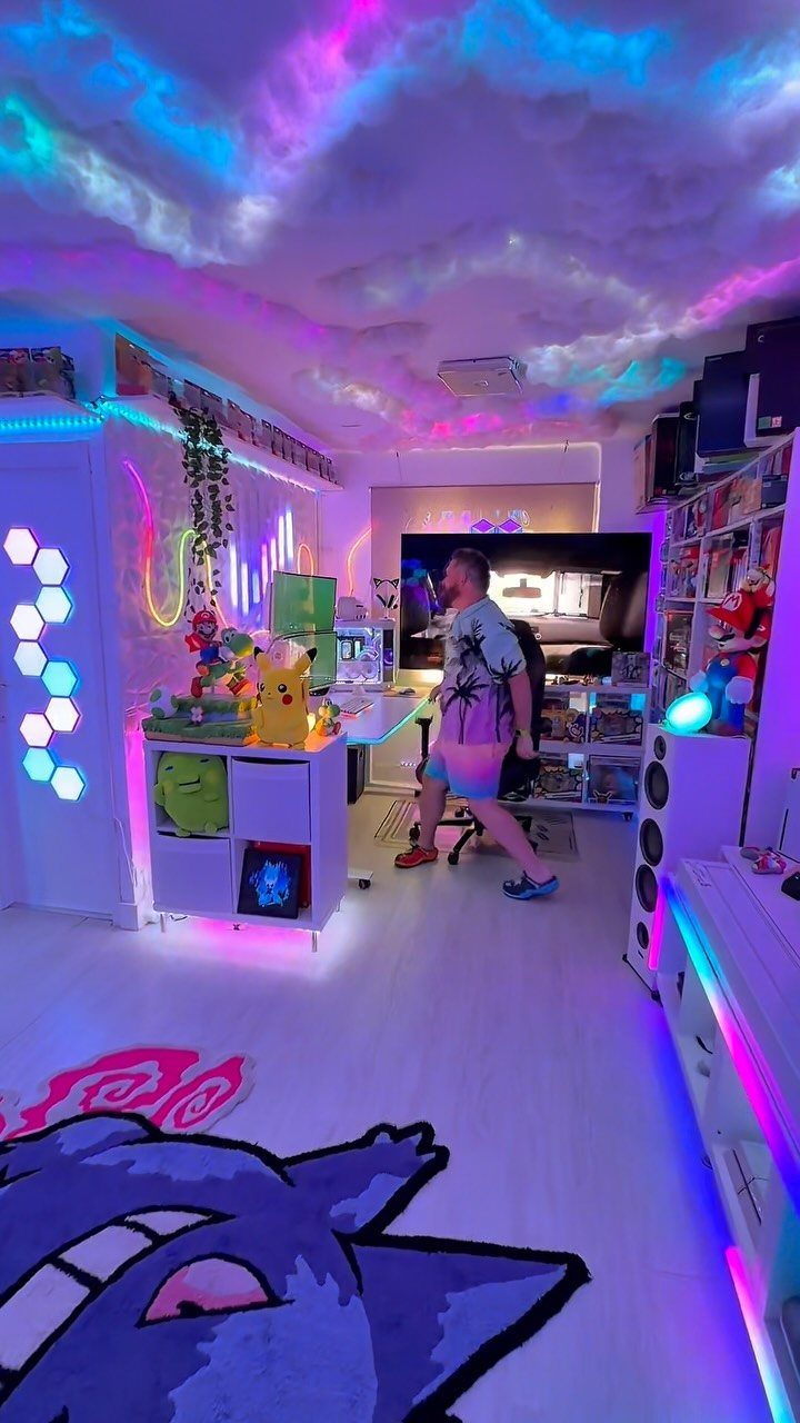 Gaming room with purple and blue neon ceiling lights and hexagonal wall panels.