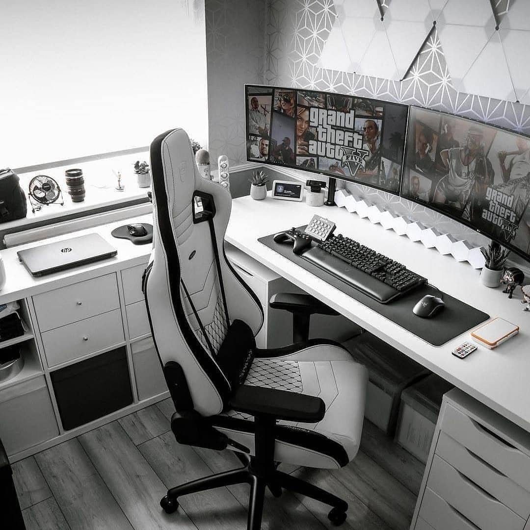Gaming setup with white desk and black and white chair in monochrome room