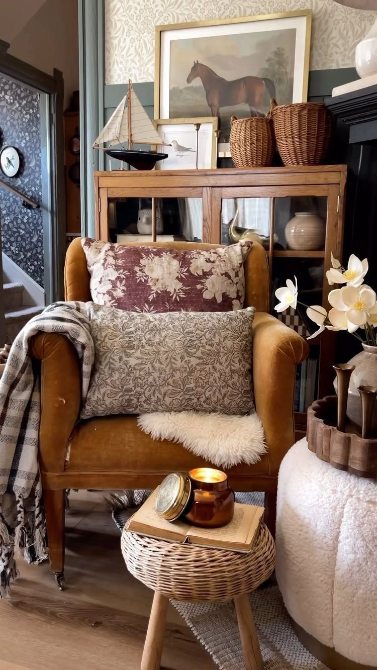 Mustard yellow velvet armchair with floral pillows in a cozy, warm-toned living room.
