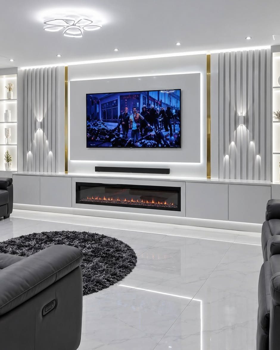 Modern home theater with integrated wall lighting, a large screen, and a fireplace.