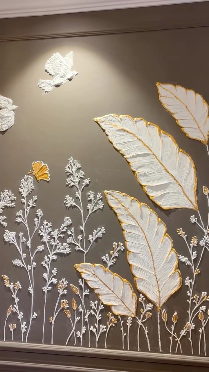 Textured wall mural with white and gold embossed leaves and birds on taupe