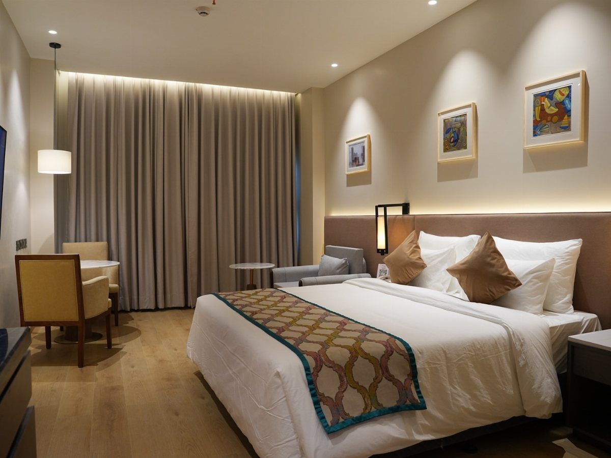 Modern hotel room with a muted color palette of beige, grey, and white.