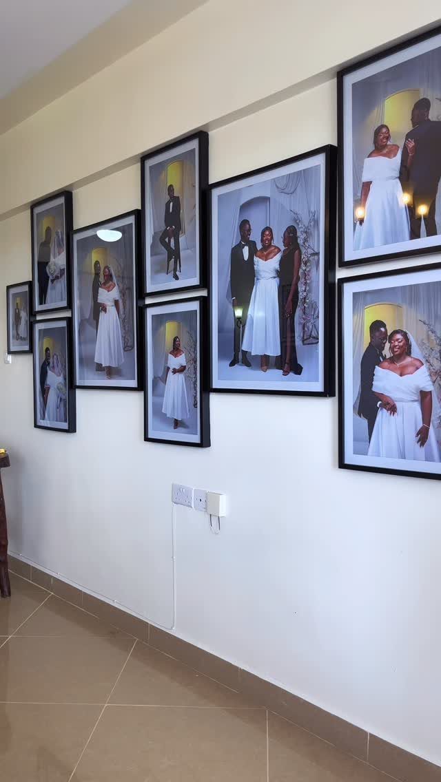 Framed photographs of a couple arranged as a gallery wall on white wall.