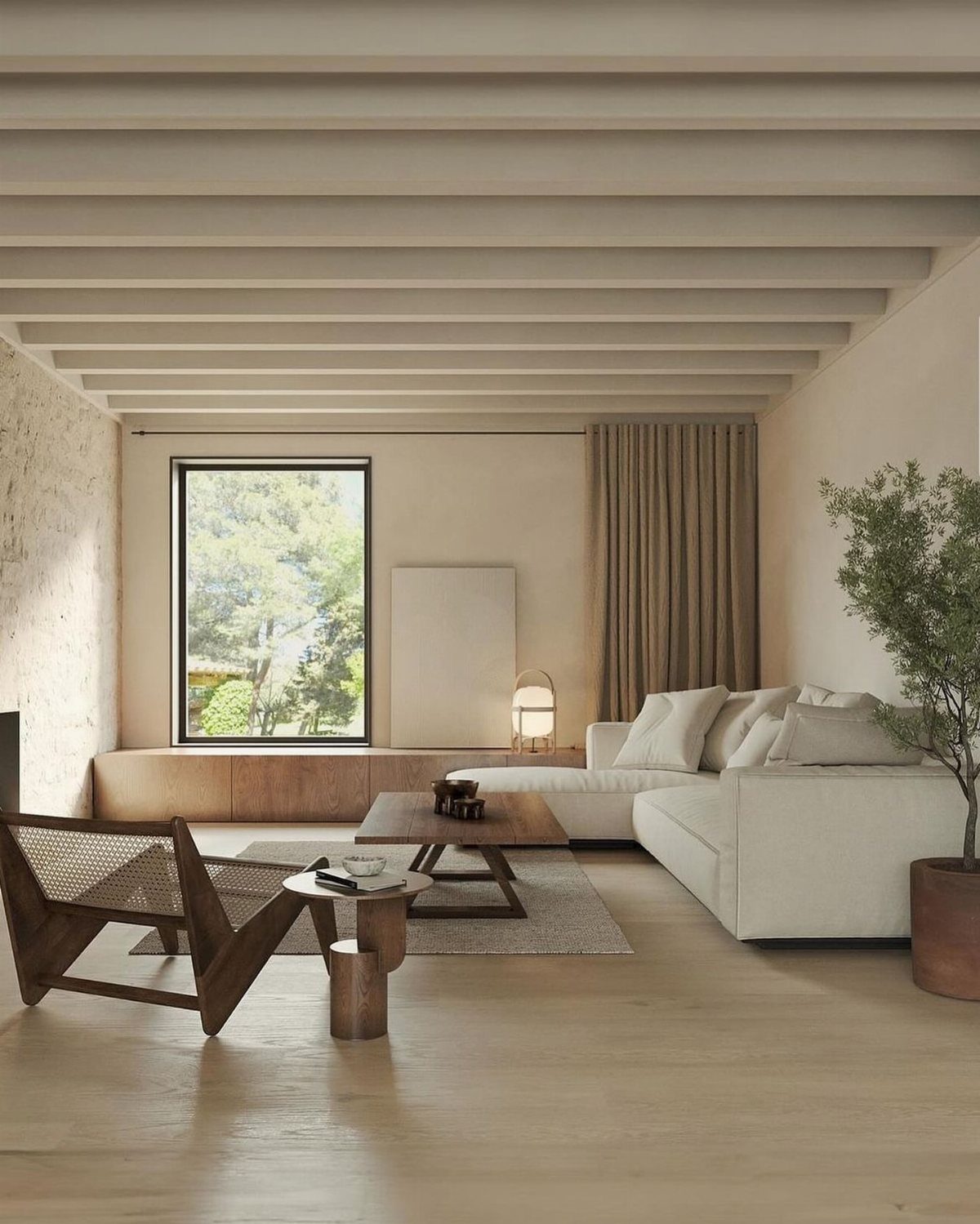 Minimalist living room with neutral tones, low wooden furniture, and a large nature window.