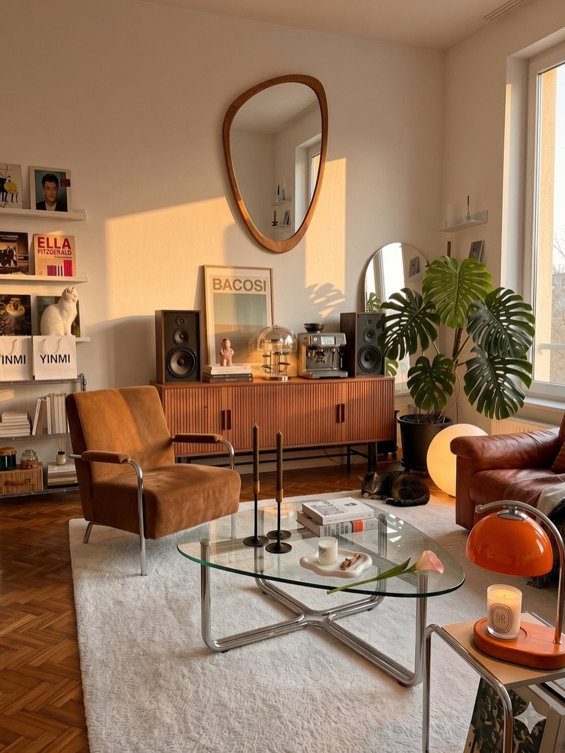 Mid-century modern living room with brown leather furniture, glass table, and oval mirror.