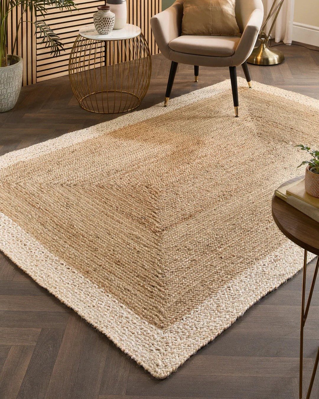 Textured jute rug in a modern living room with a beige armchair and gold table.