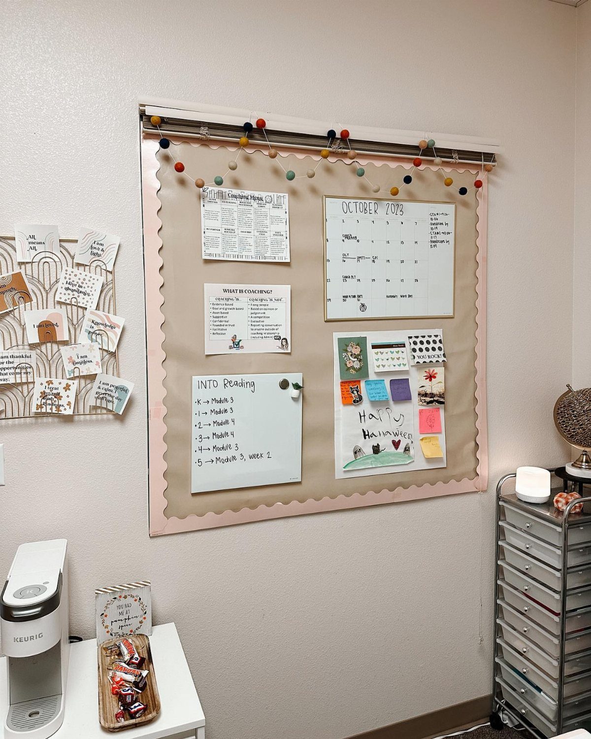 Tan cork bulletin board with pink scalloped trim holding a calendar and notes.