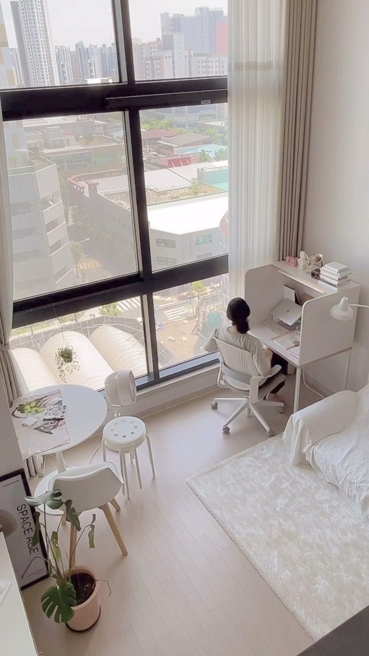 Bright white home office with a large window letting in abundant natural light.
