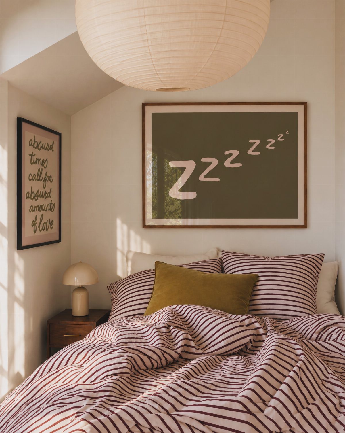 Framed art with Zzz text hanging on a white wall above a bed.