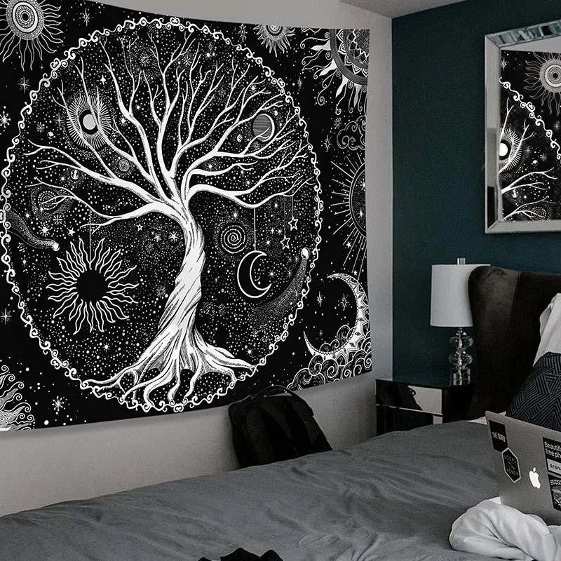 Celestial tree of life tapestry hanging on the wall above a grey bed.