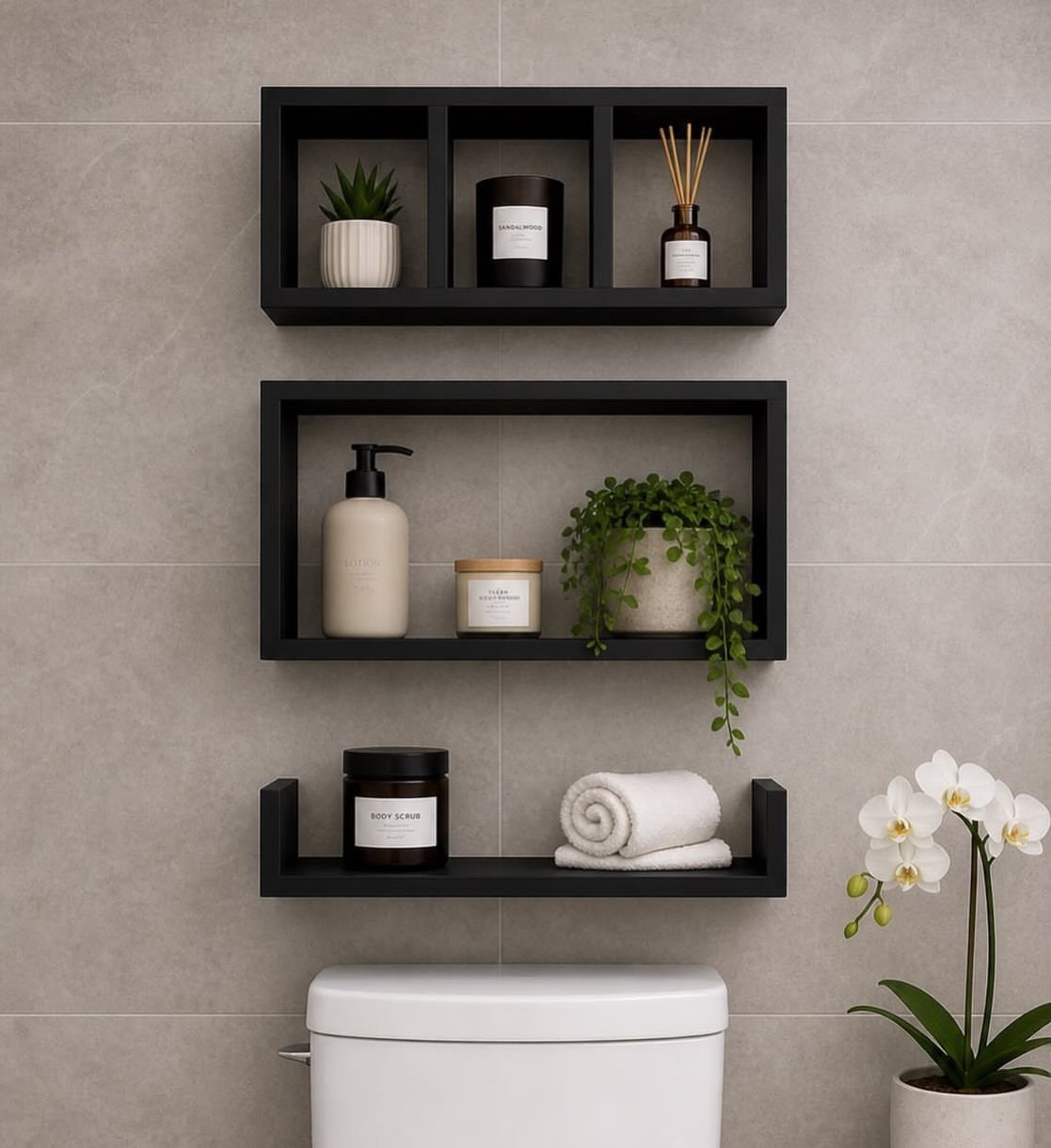Black floating shelves above a white toilet holding plants, candles, and white towels.