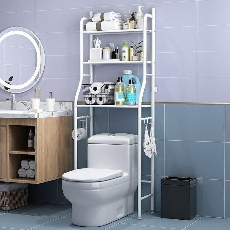 White metal shelving unit over a toilet holding towels and bathroom toiletries.