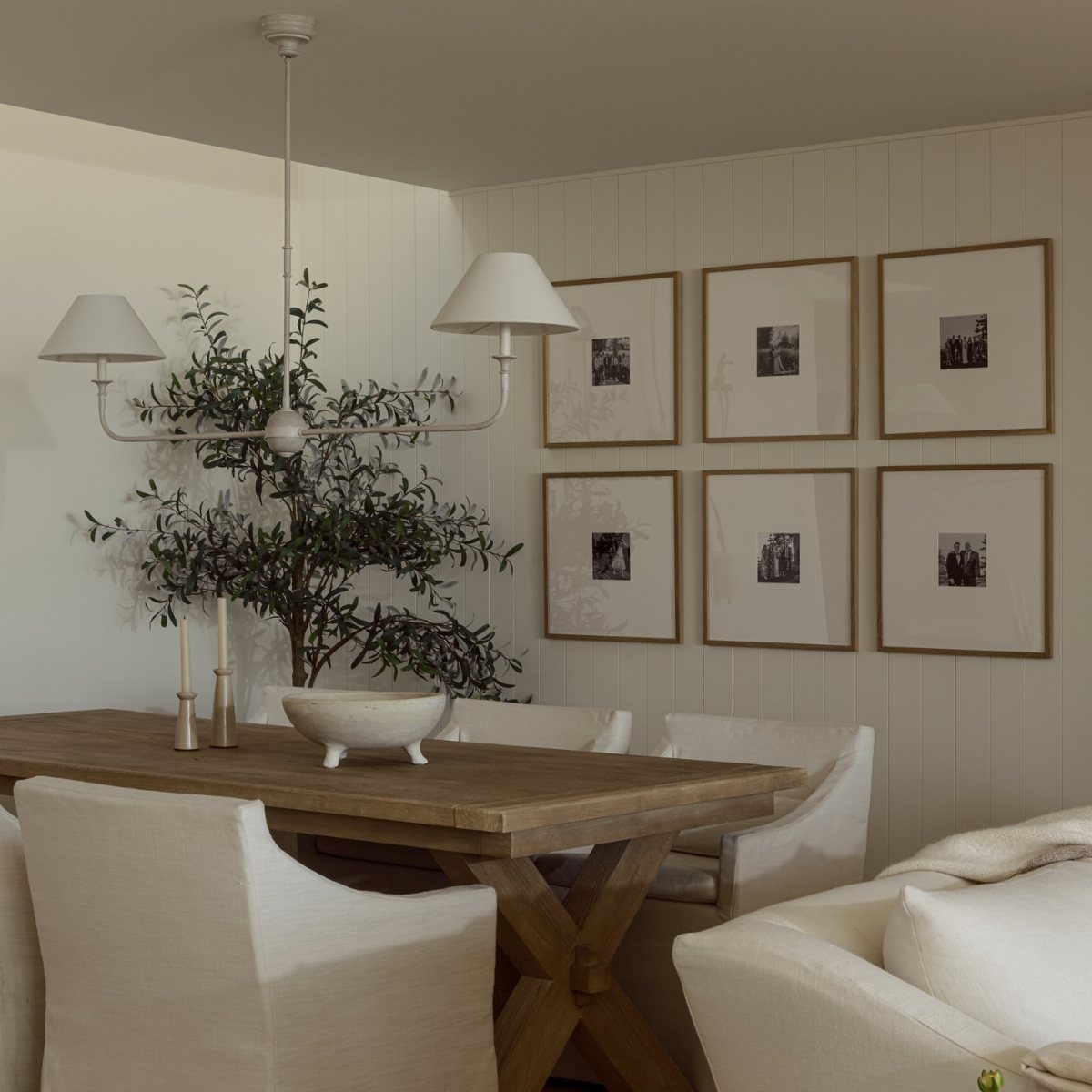 Six black-and-white photos in matching wooden frames arranged in a grid on a wall.