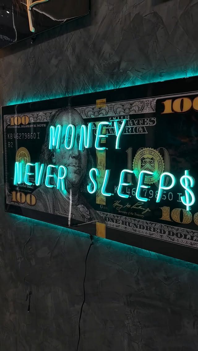 Cyan neon sign reading MONEY NEVER SLEEPS over a hundred dollar bill background