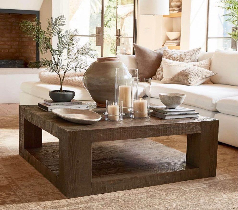 Rustic wooden coffee table made of thick beams in a bright living room
