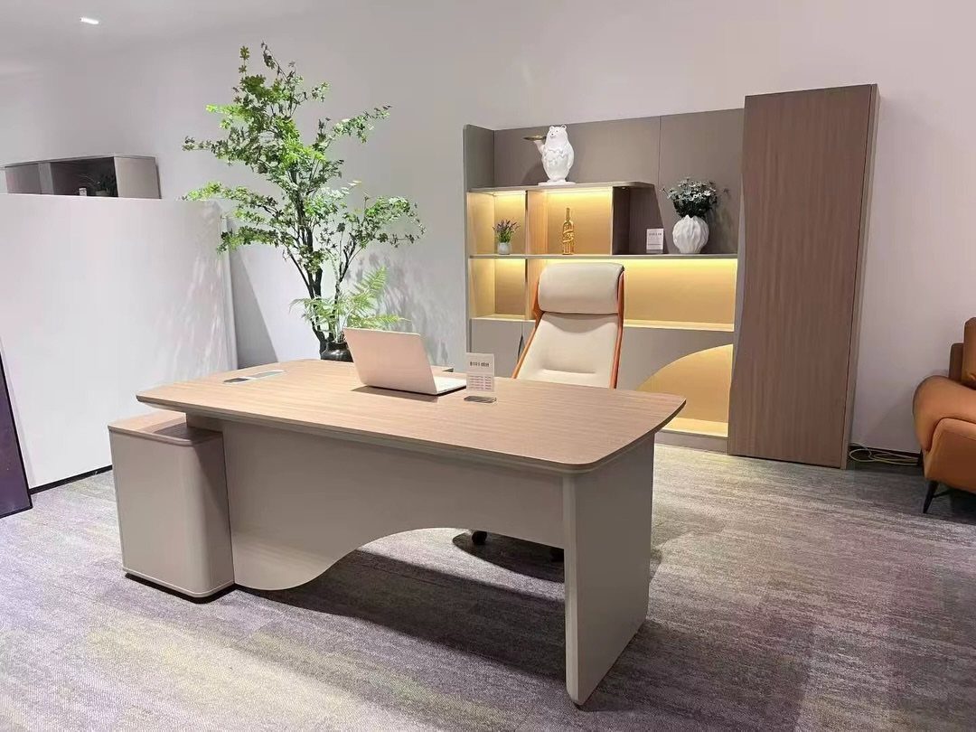 Modern office desk with light wood top, beige chair, and illuminated shelving unit.