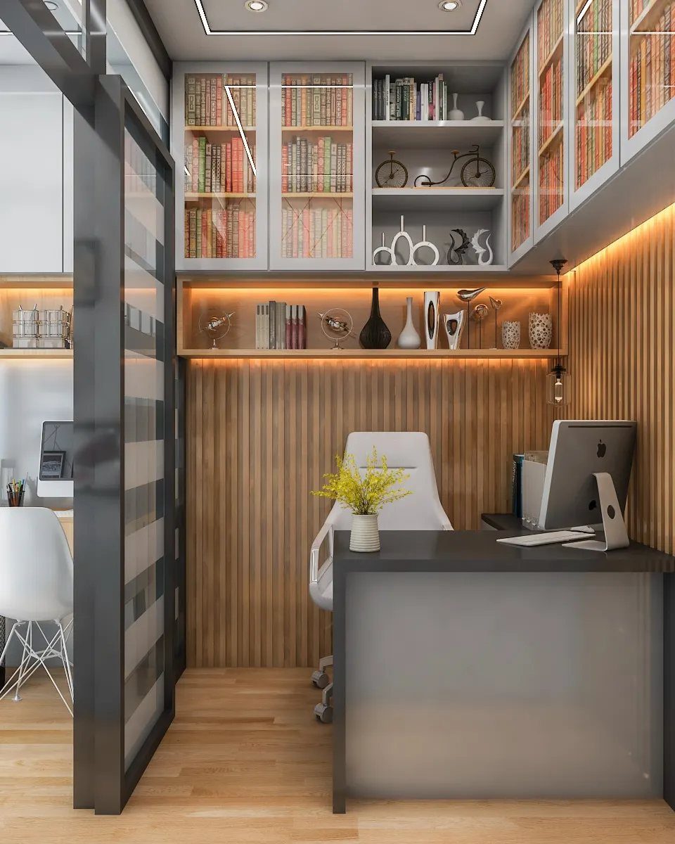 Modern small office with grey desk, wood slatted walls, and built-in shelving.