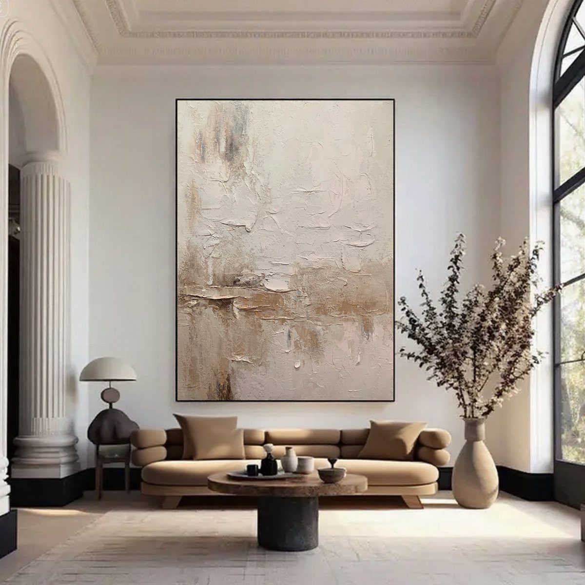Minimalist living room with beige sofa, abstract art, and neutral toned decor.