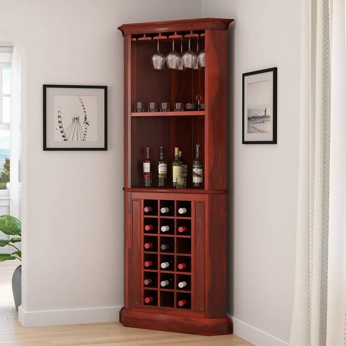 Wooden corner wine cabinet with glasses and bottles in a white room corner