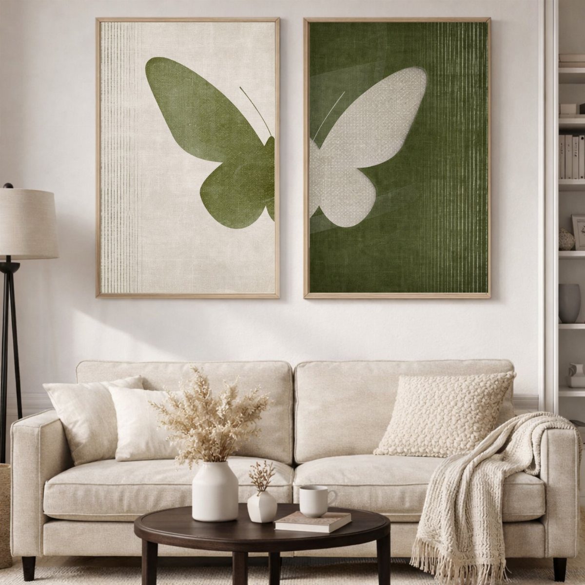 Two butterfly art prints hanging on a white wall above a beige couch