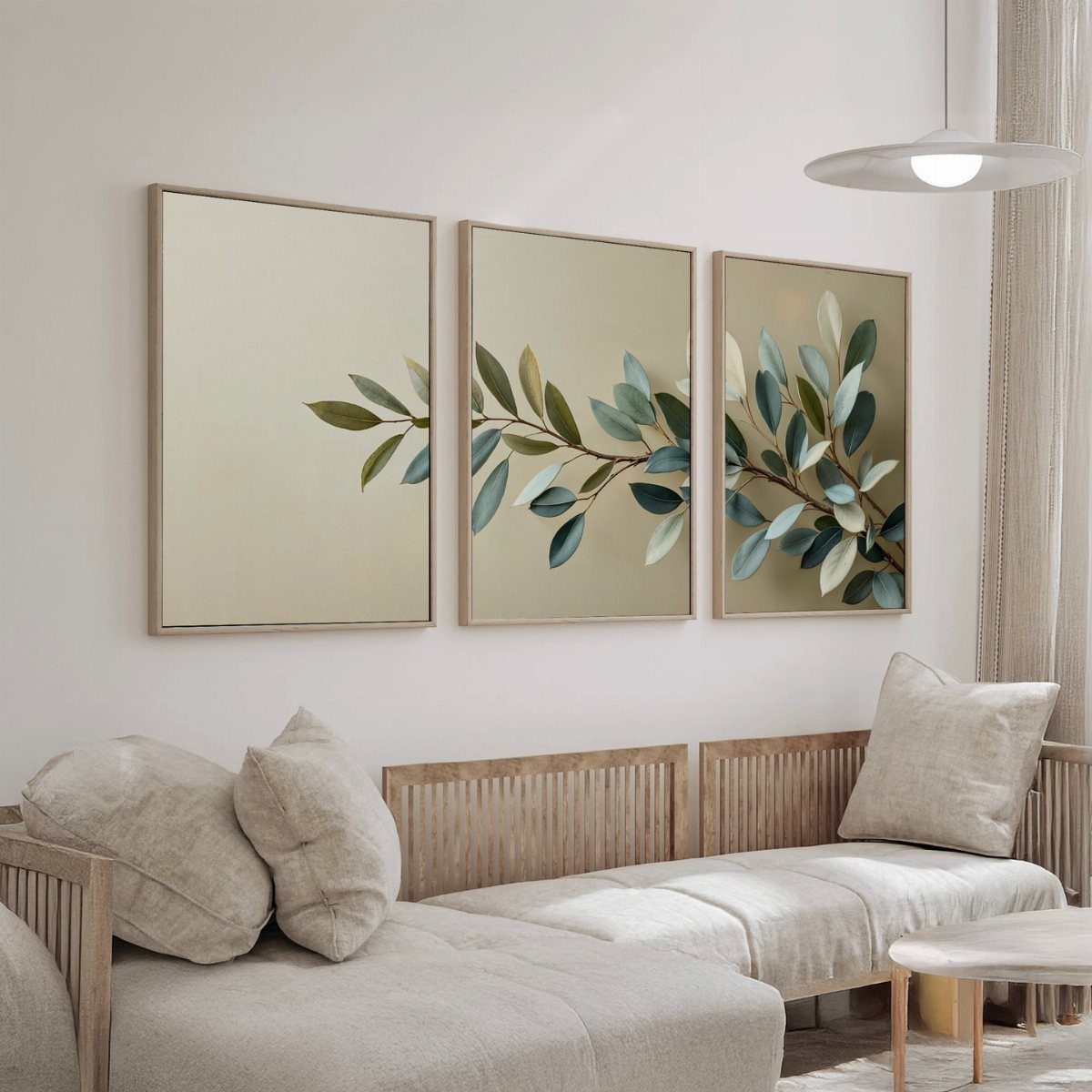 Three framed botanical art panels showing a branch above a beige modern sofa.