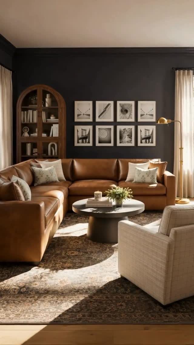 Monochromatic gallery wall with eight framed prints above a brown leather sectional sofa.